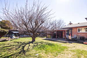 Fenced backyard with a patio area