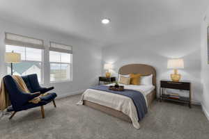 Carpeted bedroom featuring baseboards