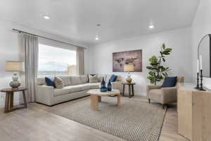 Living room with light wood-type flooring, recessed lighting, and a mountain view