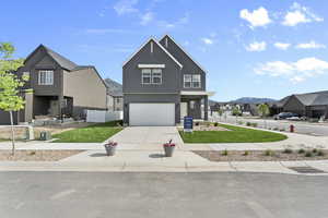 View of front facade with a residential view, an attached garage, driveway, and stucco siding