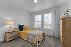 Carpeted bedroom featuring baseboards