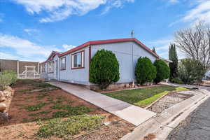 View of property exterior featuring a yard