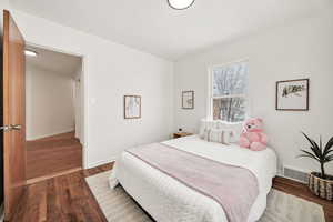 Bedroom with wood flooring