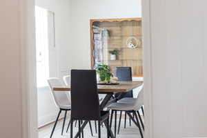 Dining room featuring natural light and wood finished floors