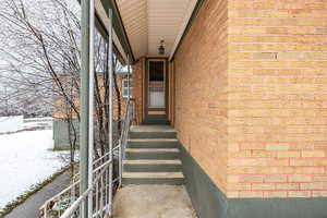 Back property entrance with brick siding