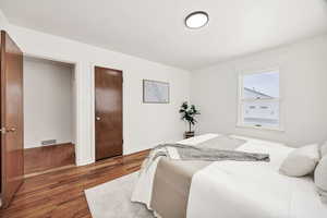 Bedroom featuring wood flooring and baseboards