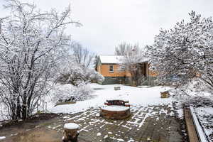 View of property exterior with an outdoor fire pit