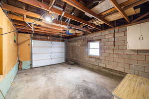 Garage with concrete block wall and a garage door opener