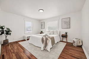 Bedroom featuring wood finished floors and baseboards