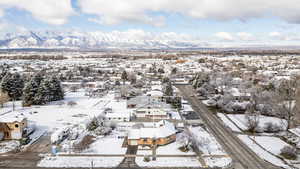 Snowy aerial view with a residential view and a mountain view