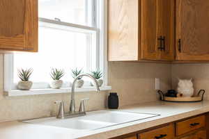 Kitchen with wood finish cabinetry and light countertops