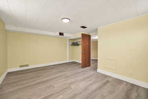 Spare room with baseboards and laminate flooring