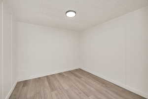 Unfurnished room with flooring and baseboards