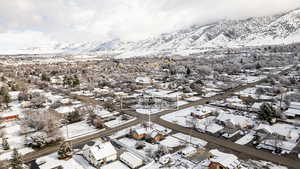 Snowy aerial view with a residential view and a mountain view