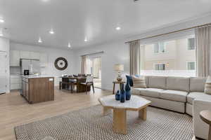 Living room featuring recessed lighting and light wood-style flooring
