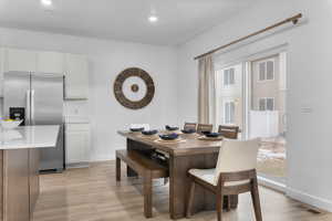 Dining space featuring light wood finished floors and recessed lighting