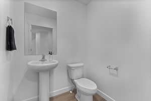 Bathroom featuring toilet and light wood-style floors