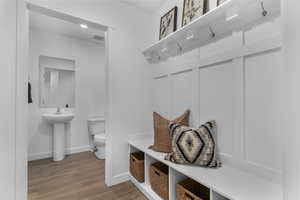 Mudroom with baseboards and wood finished floors
