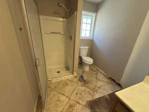 Bathroom featuring a stall shower, vanity, and light tile patterned floors