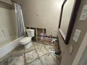 Full bathroom featuring shower / bathtub combination with curtain and light tile patterned floors