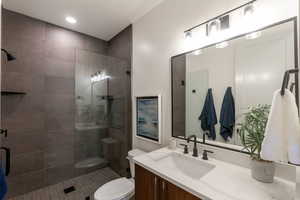 Bathroom with vanity, a shower stall, and recessed lighting