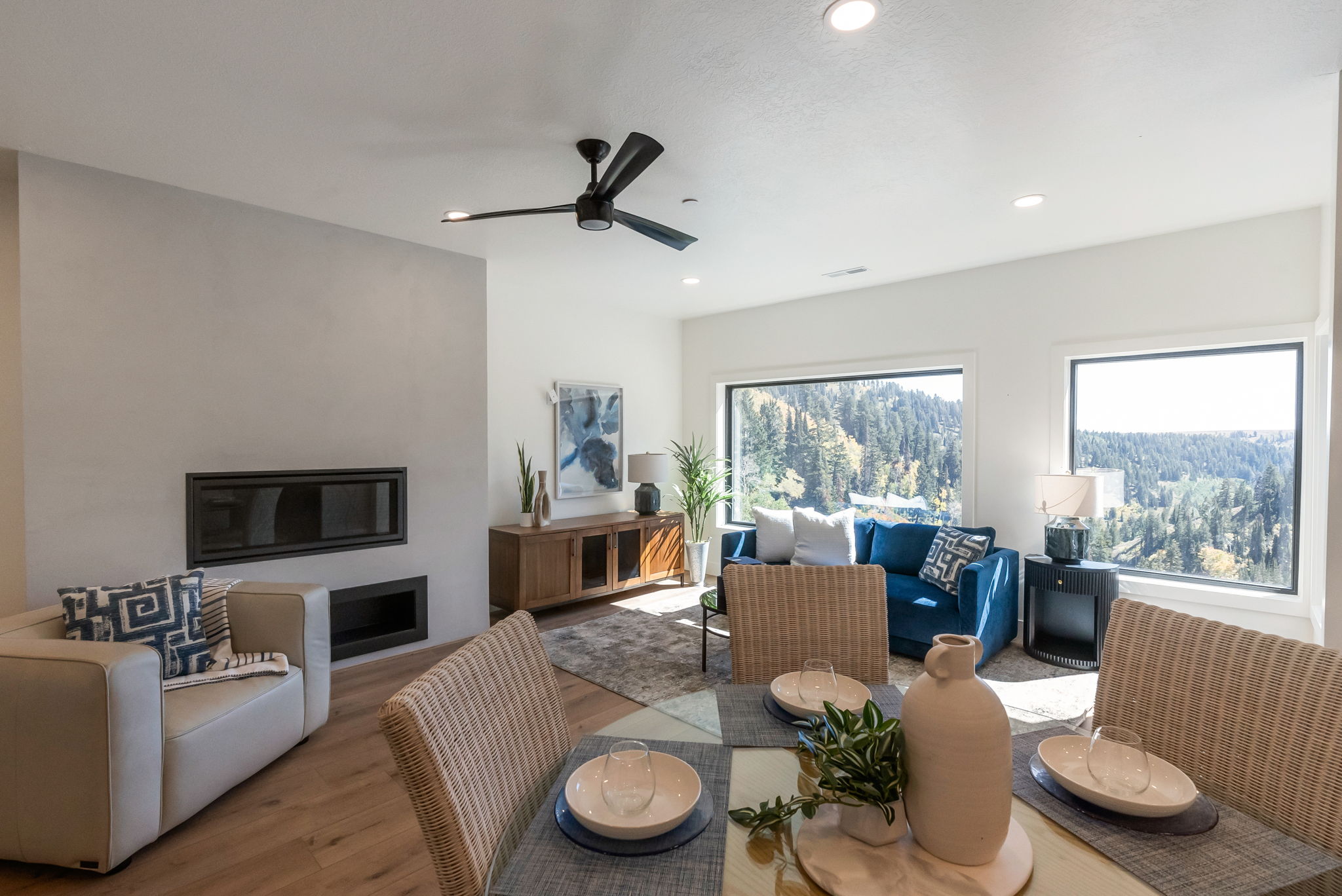 Dining area with wood finished floors, ceiling fan, a glass covered fireplace, and recessed lighting