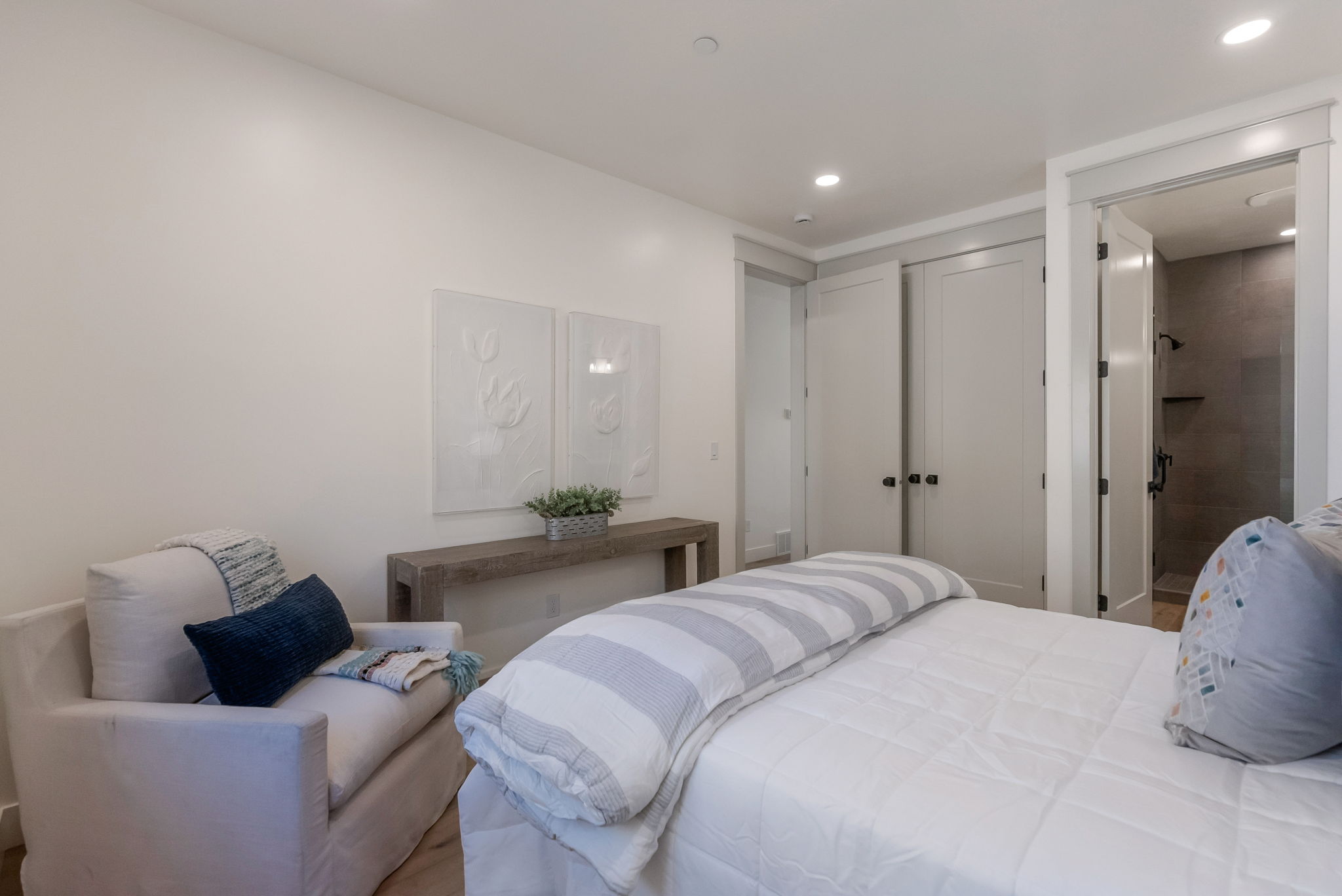 Bedroom featuring recessed lighting and connected bathroom