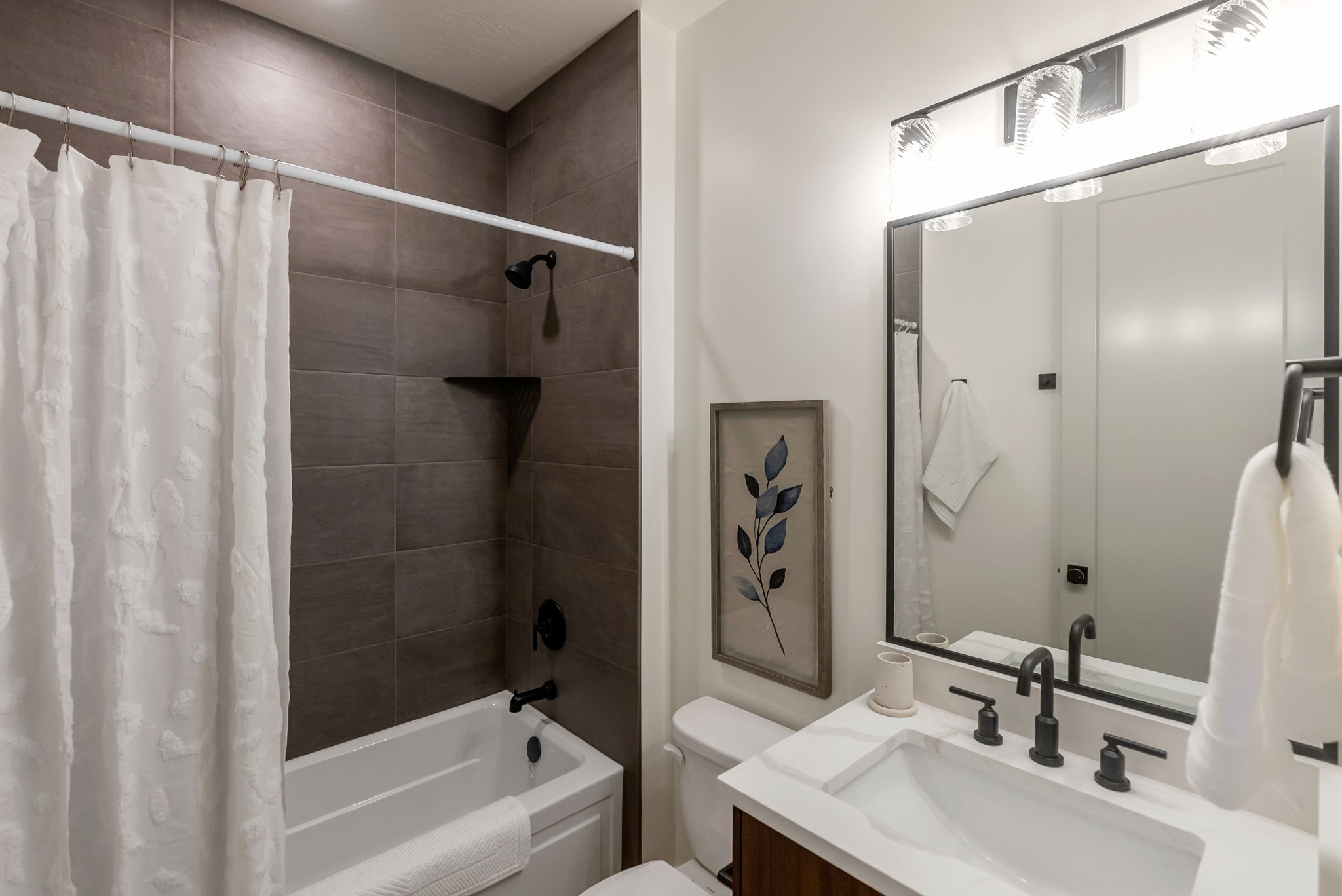 Bathroom featuring vanity and shower / bath combo with shower curtain