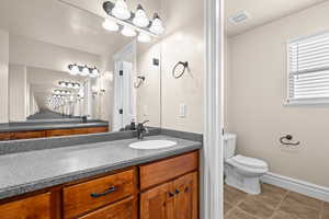 Bathroom with vanity and light tile patterned floors