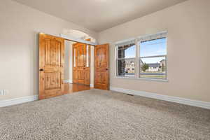 Unfurnished bedroom with a closet and carpet