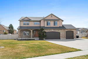 View of front of property featuring concrete driveway, stone siding, stucco siding, covered porch, and roof with shingles