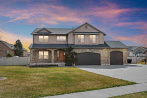 View of front of house featuring stone siding, concrete driveway, stucco siding, and covered porch