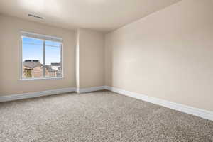 Empty room with baseboards and light carpet