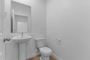 Bathroom featuring toilet and wood finished floors