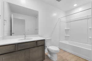 Bathroom with vanity, light wood-type flooring, and shower / bath combination