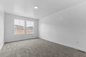 Empty room with baseboards and carpet flooring