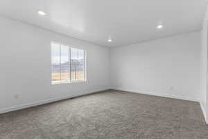 Unfurnished room with carpet flooring, recessed lighting, and a mountain view