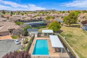 Aerial view of residential area featuring a pool and a mountain backdrop