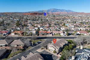 Aerial perspective of suburban area with a mountain backdrop