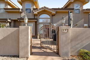 View of front of house featuring a gate, a fenced front yard, and stucco siding