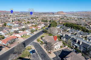Aerial overview of property's location with a mountain backdrop and nearby suburban area