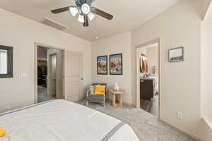 Carpeted bedroom with a ceiling fan and baseboards