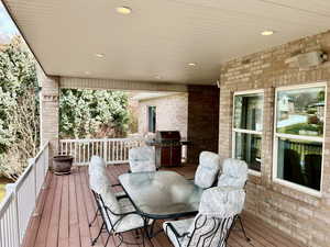 Deck with outdoor dining space and grilling area