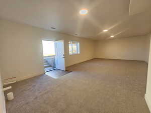 Empty room with carpet flooring and recessed lighting