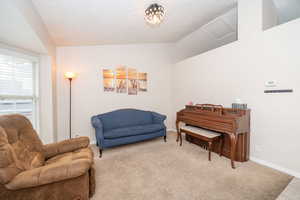 Sitting room featuring carpet and baseboards