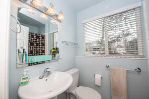 Full bath featuring a shower with shower curtain and plenty of natural light