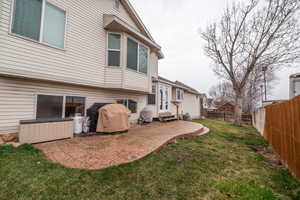 Fenced backyard with a patio and entry steps