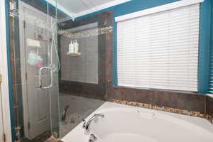 Full bathroom with a shower stall and a bath