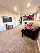 Living area with crown molding, carpet flooring, and recessed lighting