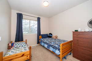 Carpeted bedroom with baseboards